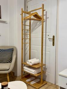 a wooden towel rack in a room with a door at The Nest - Cozy Stay in Arcadia in Tripolis