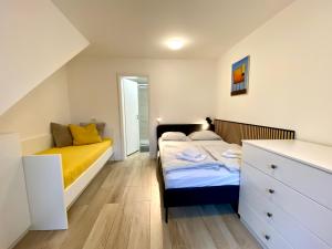 a bedroom with a bed and a dresser at Bohinj - Old Village House in Bohinj