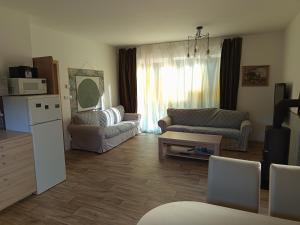 a living room with a couch and a table at Pod Sedlem in Loučná nad Desnou