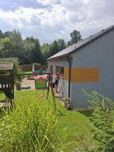 a woman playing with a frisbee in a yard at Pod Sedlem in Loučná nad Desnou