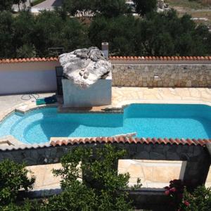 vista sul tetto di una piscina con fontana di Apartments Kafadar a Trogir