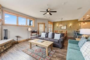 a living room with a couch and a table at Walk to Main Street Hot Tub Gym and Game Room in Breckenridge