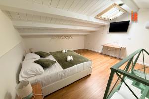 a bedroom with a bed with two stuffed animals on it at La Casetta nel Borgo in Cerisano