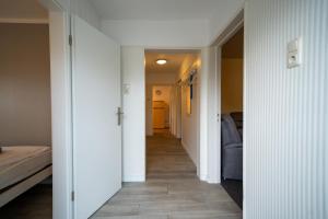 a hallway with white walls and a hallway with a hallwayngthngthngth at Haus Sonnenwinkel Ina in Dahme