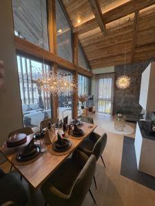 a dining room with a wooden table and chairs at Aloha Suite - Schladming Dachstein in Haus im Ennstal