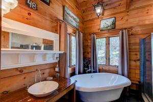 a bathroom with a large tub and a sink at Boles Lodge in Boone +43 photos