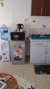 a kitchen with two refrigerators and a counter top at Budget bliss4 bnb Ruaka in Ruaka +12 photos