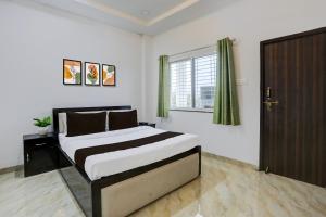 a bedroom with a bed and a window and a door at HOTEL O SPACE INN NH 44 in Pānchgaon