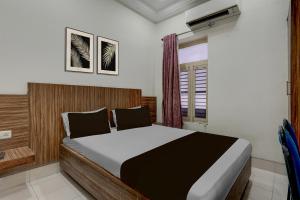 Postel nebo postele na pokoji v ubytování Hotel O Sindhuri Vijayawada Junction