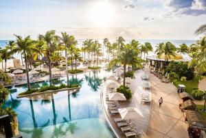 a view of a pool at a resort with palm trees at Villa Del Palmar Cancun Luxury Beach Resort Spa in Cancún
