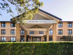 a large building with a sign in front of it at Mercure Sydney Manly Warringah in Sydney