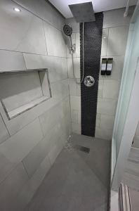 a bathroom with a shower with a sink and a shower at Casa Fortuna Near Luquillo Beach & El Yunque in Luquillo +30 photos