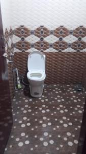 a bathroom with a toilet in a room at New royal home stay in Varkala