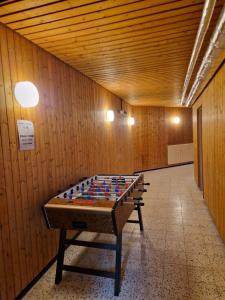 a ping pong table in the middle of a room at Foresty Appartement in Schonach