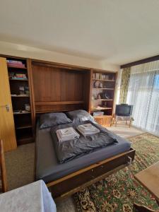 a bedroom with a bed with a wooden headboard at Foresty Appartement in Schonach