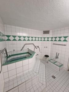 a bathroom with a bath tub and a sink at Foresty Appartement in Schonach +18 photos