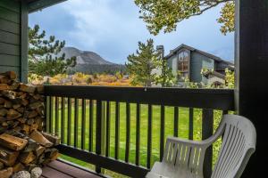 a white chair sitting on a porch with a view at 3 Bedrooms + Loft townhome in Snowcreek Phase 3, Private Pool Table Sleeps 6 Guests, Dog Friendly in Old Mammoth