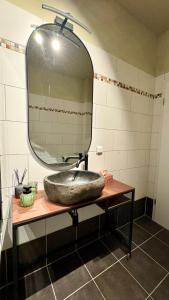 a bathroom with a sink and a large mirror at Nordic Zen Loft mit Garten in Magdeburg