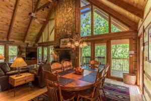 a dining room and living room with a table and chairs at Almost Heaven in Sugar Grove
