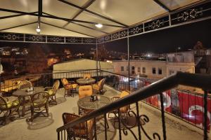 a balcony with tables and chairs and a view of the city at View Cave Hotel in Goreme
