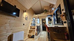 a tiny house with a kitchen and a bar at Tiny House Kota Grill & Sauna in Yébleron