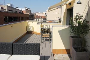 
a patio area with chairs, tables and umbrellas at Mercure Madrid Centro in Madrid
