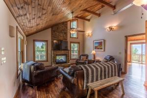 a living room with leather furniture and a fireplace at Grandview Getaway in Boone