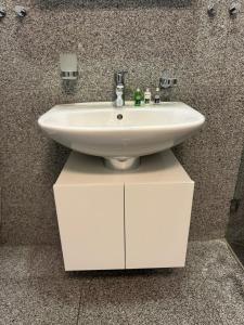 a white sink on top of a cabinet in a bathroom at Bergstudio II I Flims I Laax I Ski I Caumasee in Flims