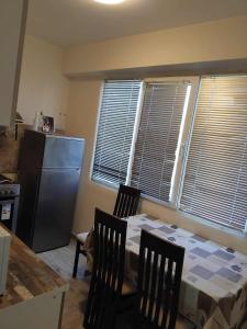 a kitchen with a table and chairs and a refrigerator at Tedy in Oryakhovo