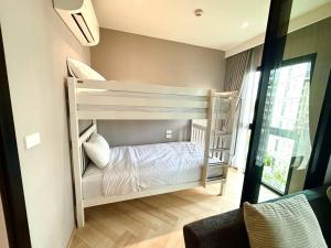 a bedroom with two bunk beds in a room at The Legendary Bang Tao 2-bedrooms apart #402 in Bang Tao Beach