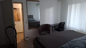 霍恩-巴特迈恩贝格Cozy apartment in Horn-Bad Meinberg!的一间卧室配有一张床、两把椅子和一扇门