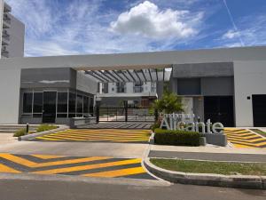 a building with a parking lot in front of it at Condomio Alicante Bahia Solero in Ricaurte