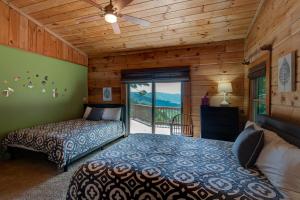 a bedroom with two beds and a balcony at 1 Sublime View in Boone