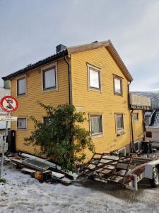 a yellow house is being transported on a trailer at Nordstay Tromso in Tromsø