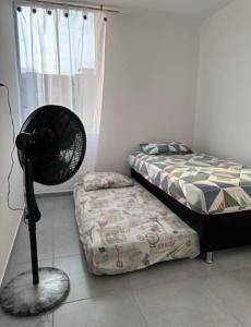 a bedroom with a fan next to a bed at Condomio Alicante Bahia Solero in Ricaurte