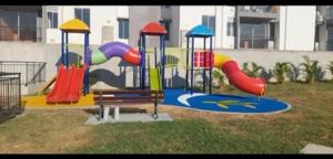 a playground with colorful slides and a bench at Condomio Alicante Bahia Solero in Ricaurte