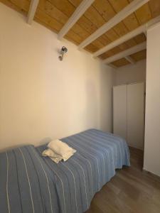a bedroom with a bed with a blue striped blanket at LOFT a PORTOVENERE in Fezzano +38 photos