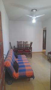 a bed sitting in a room with a ceiling at Perto do peixe Marley - Praia do Morro in Guarapari
