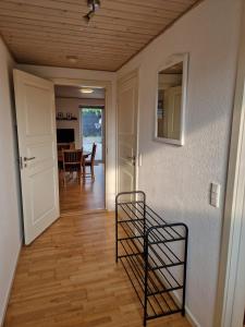 a room with a hallway with a door and a mirror at Lejlighed i Gråsten in Gråsten