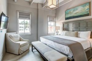 a bedroom with a large bed and a chair at Parker's Collection - 4 Bedroom in Savannah +27 photos
