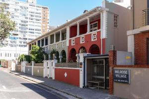 a building on the side of a street at Melrose Tide 1 Bed Spacious Apartment in Muizenberg