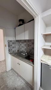 a small kitchen with a sink in a room at la petite sirène in Mahdia