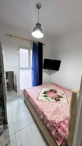 a bedroom with a large bed in a room with a window at la petite sirène in Mahdia