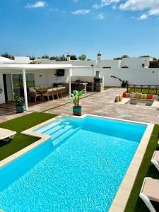 a swimming pool in the backyard of a house at The Suite Villa in Playa Blanca