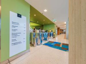 a lobby with a sign in the middle of a building at Mercure Tallinn in Tallinn