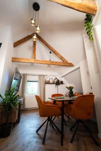 a dining room with a table and chairs at Lumé35 in Hachenburg