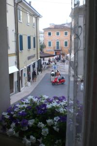 a view from a window of a street with flowers at Ca' Ottocento in Lazise