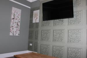 a living room with a wall with a flat screen tv at Apartment 1 at Blackburn Heights Sleeps 2 in Bridlington