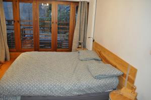 a bedroom with a bed and a window at Chambre suite de L'argentier in Noyarey