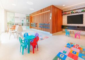 a room with colorful chairs and a table and a tv at Salinas Exclusive Resort in Salinópolis